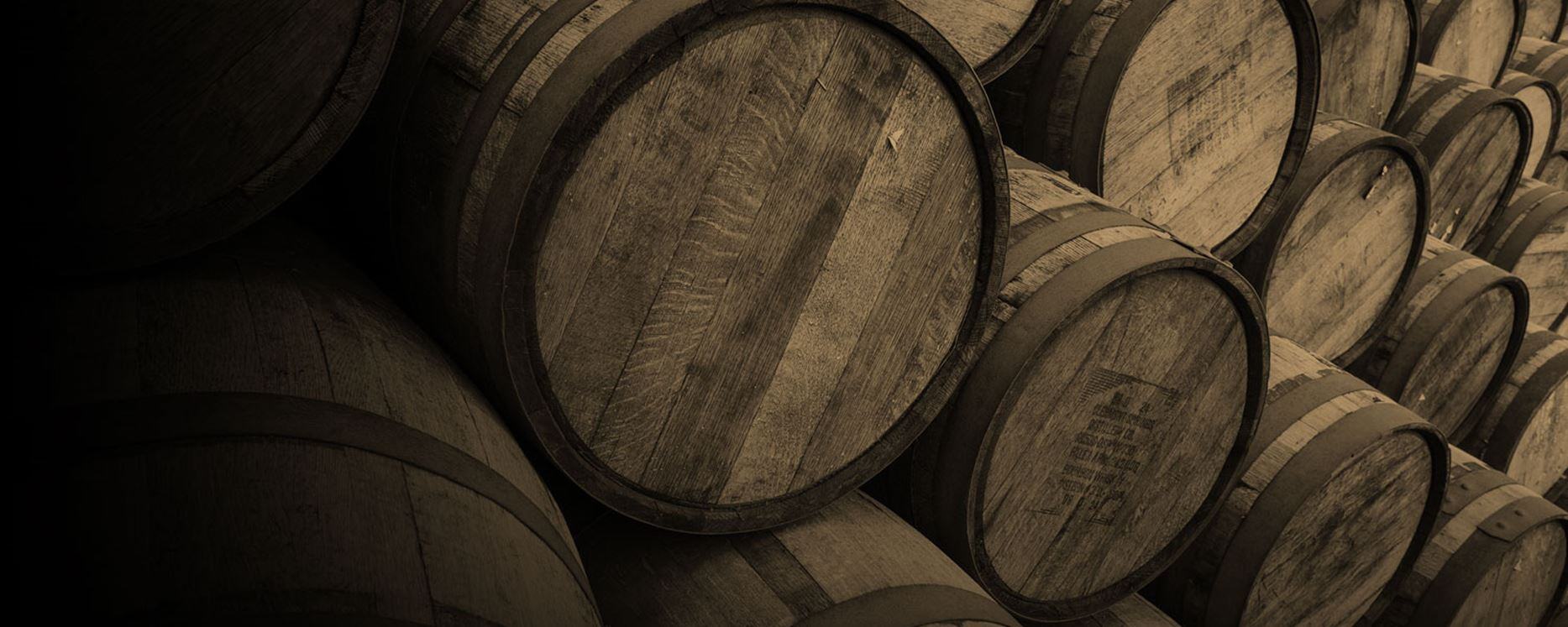 a large amount of stacked whisky barrels in a Gordon and MacPhail warehouse